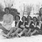 Members of the 1948 Carnival court, including Queen Jeanne Mather, pose atop a toboggan.