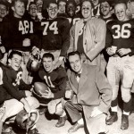 Then: (November) With Coach Bob Hatch at center, the 1956 Bobcats celebrate their 38-13 win over Colby, a victory that netted Bates football the State Series Championship and Governor Barrows Trophy.   Photographer unknown, 1956, gelatin silver print, the Edmund S. Muskie Archives and Special Collections Library.
