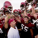 Now: (November) Bates football coach Mark Harriman joins the traditional singing of the Bates fight song after a 20-17 Garcelon Field victory over Bowdoin College in 2003.   Photograph by Phyllis Graber Jensen.