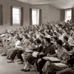 Then: (December) A Cultural Heritage class in Pettigrew Hall's Filene Room listens attentively to Rayborn Zerby, professor of religion and chair of the "Cultch" program.  Photograph by William M. Rittase, circa 1954, gelatin silver print, the Edmund S. Muskie Archives and Special Collections Library.