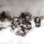 Then: (February) During the long Maine winter you have to make your own fun. Shown tobogganing are (from left) Alexander Somerville '50, Elaine Harvey '49, Bill Simpson '49, Joyce Lyons '50 and Mary Petro, wife of basketball coach Edward Petro.  Photographer unknown, 1950, gelatin silver print, the Edmund S. Muskie Archives and Special Collections Library.
