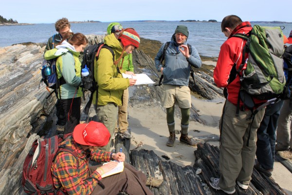 Camille Parrish and Dykstra Eusden lead a field trip to Maine's Cliff Island to teach students how to identify and measure the different rock formations to create a surficial geology map in ArcGIS.
