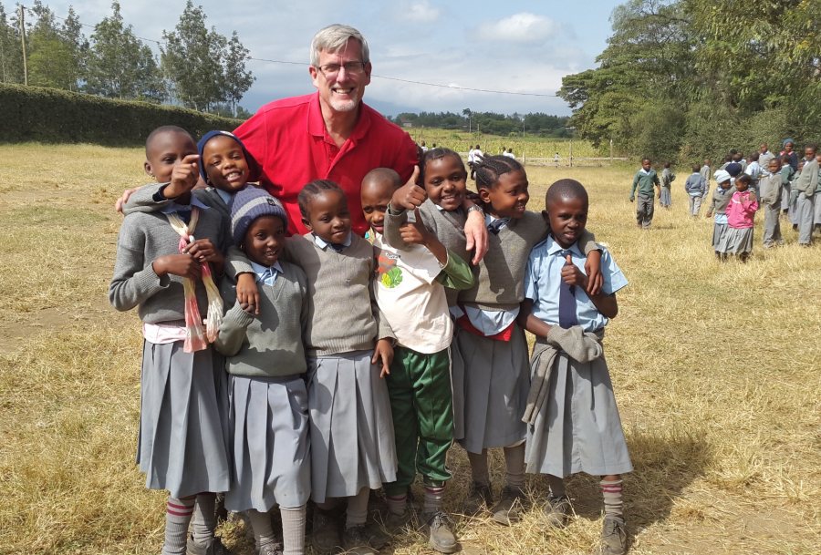 Bruce Fryer '79, awarded a Barlow Alumni Travel Grant to teach at the the Maasai Joy Children’s Centre in Arusha, Tanzania, for two weeks in summer 2015, poses with some of his students during field day festivities. 
