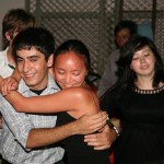 Farewell dinner party, hug exchange.