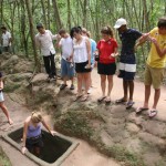 Visiting Cu Chi Tunnels. Krystina going down in tunel.