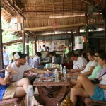 Students relaxing and enjoying tropical fruits, Mekong Delta.