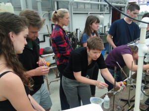 Lyndell Bade AI helps students with a greenhouse experiment examining factors that affect transpiration in plants.