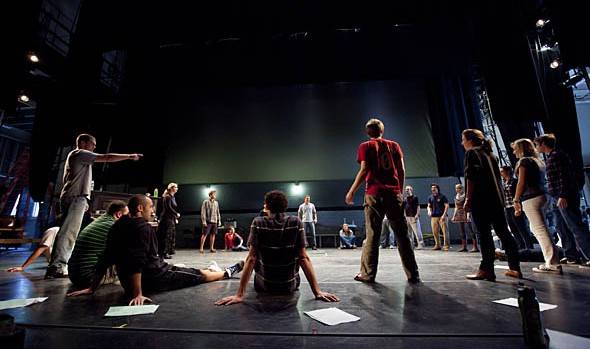 Lecturer Katalin Vecsey (standing, second from left) teaches her voice and speech course on the stage of Schaeffer Theatre.