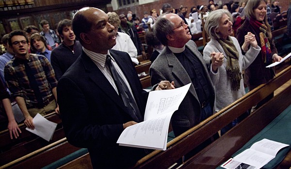 From left, Associate Dean of Students James Reese joins Bates Multifaith Chaplain Bill Blaine-Wallace, Victoria Blaine-Wallace and Associate Multifaith Chaplain Emily Wright-Magoon in singing "We Shall Overcome."