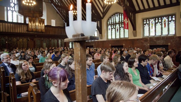 Gathered students, staff, and faculty fill the College Chapel pews during a memorial service for Evan Dube  '15.
