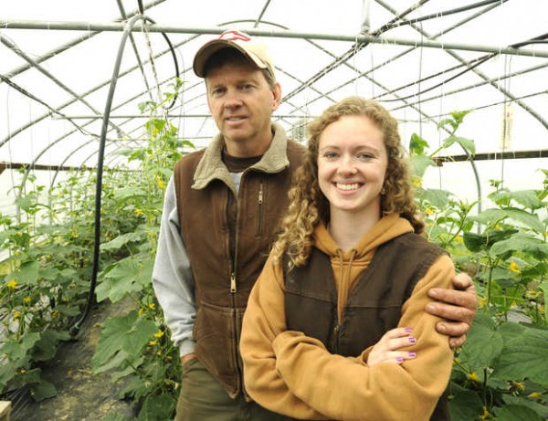 Tomi Chipman '14 stands with her father, Doug, in one of their greenhouses in Poland. Photograph by Jose Leiva/Sun Journal.