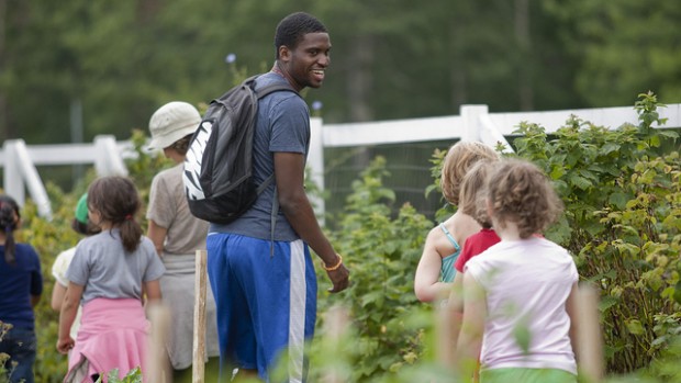 Among the Harward Center's initiatives is the Community-Based Research program, which allows students to connect service and academics. Above, David Longdon '13 helps lead youth programming with Lots to Gardens, a community garden program in Lewiston. Photograph by Phyllis Graber Jensen/Bates College