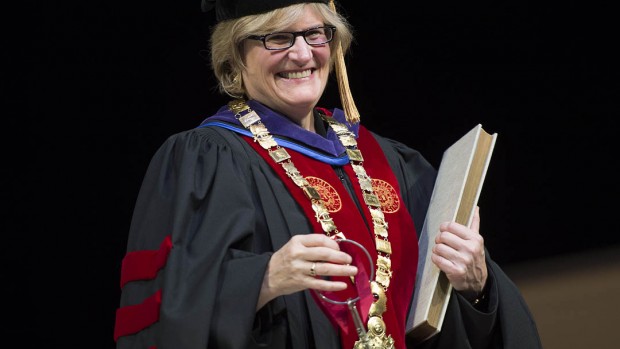 Clayton Spencer holds the symbols of office during her installation ceremony as the eighth president of Bates College. The symbols are the keys, the presidential collar and the record book.