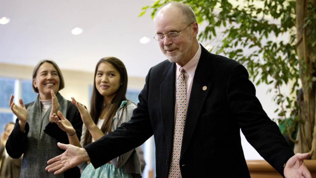 At the Jan. 18 retirement reception in his honor, Bill Hiss '66 acknowledges applause for his contributions to Bates. At left are his wife, Colleen Quint '85, and daughter, Jessie. Photograph by Phyllis Graber Jensen/Bates College.