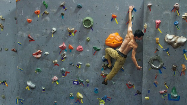 Chester Chiao '13 trains on the rock wall in Merill Gymnasium Photograph by Phyllis Graber Jensen/Bates College