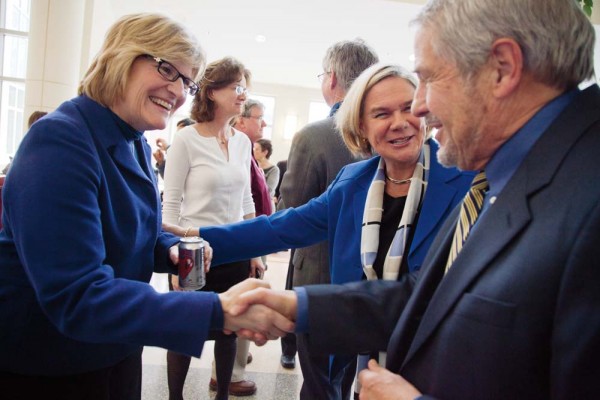 A historic moment as Interim President Nancy Cable introduces the president-elect to President Emeritus Donald Harward in Perry Atrium during a celebration of new appointments to Bates faculty professorships. Photograph by Phyllis Graber Jensen/Bates College.