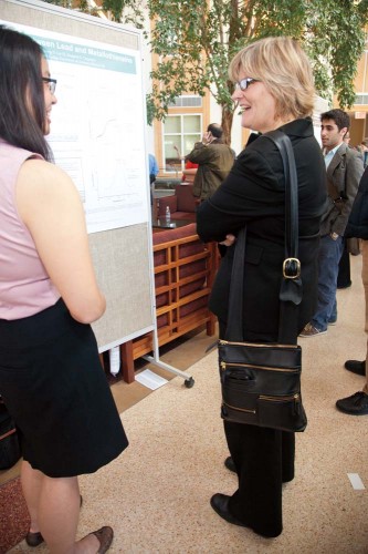 Angela Su ‘12 of Flushing, N.Y., explains her research poster, “Lead Interactions with Metallothionein-3,” to the Bates president-elect at the 2012 Mount David Summit. Photograph by Phyllis Graber Jensen/Bates College.