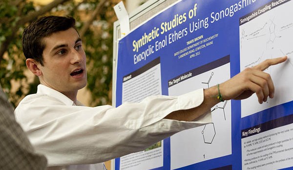 Travis Brown '11 of East Greenwich, R.I., explains his chemistry poster, "The Synthesis of Exocyclic Enol Ethers Using Sonogashira Couling," at the 2011 Mount David Summit. Photograph by Phyllis Graber Jensen/Bates College.