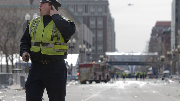 A Boston police officer shouts instructions on Boylston Street in Boston on April 15, 2013. Photograph by Bates photographer Mike Bradley, who was at the marathon earlier in the day and returned to cover the aftermath for a New York City media outlet.