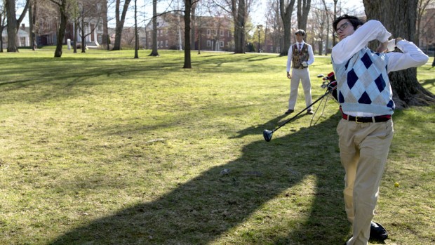 Jon Pelz '16 (right) and his twin brother Chris Pelz '16 practice golfing with foam golf balls on the Historic Quad. (Mike Bradley/Bates College)