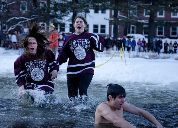 Puddle Jump participants take the plunge into frozen Lake Andrews during Winter Carnival. Run by the college’s historic student Outing Club, the premise is simple: Cut a hole in the ice of Lake Andrews and invite anyone to jump in. Photograph by Phyllis Graber Jensen/Bates College.