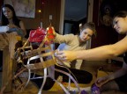 From left, Kahea Mueller '15, Linnea Brotz '15 and Singha Hon '14 work on their group design for the Trashion Show. (Sarah Crosby/Bates College)