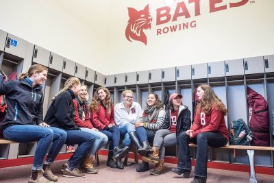 Members of the women's team gather in their new locker room. (Andree Kehn for Bates College)