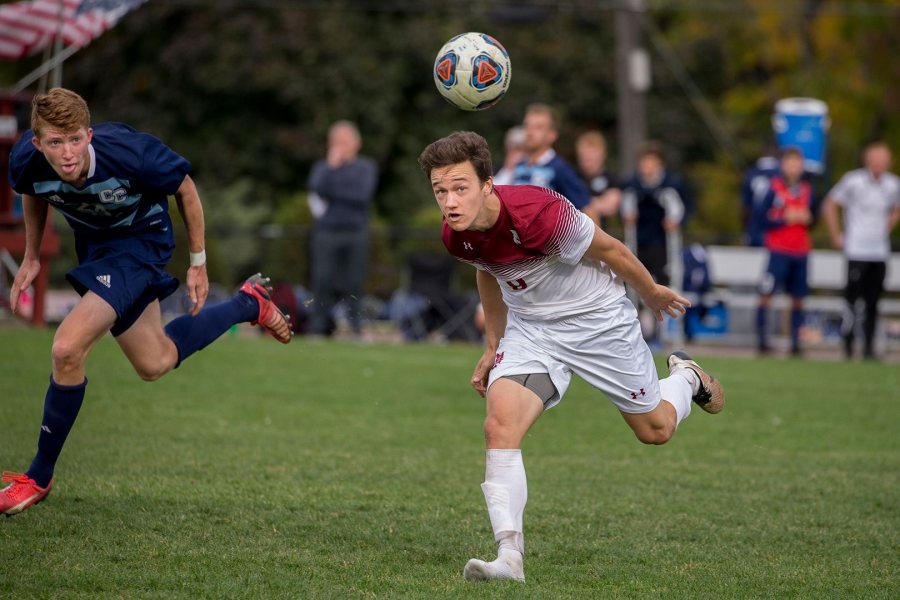 Shown heading the ball to a teammate against Connecticut College a year ago, Nate Merchant '18 has been men's soccer's leading scorer each of the past two seasons. (Phyllis Graber Jensen/Bates College)