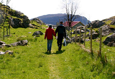 Skarstad worked for Norwegian sheep farmers Anders Braanaas and Hilde Buer, seen here walking hand in hand on an island adjacent to Grøneng Island, where Buer has her farm.