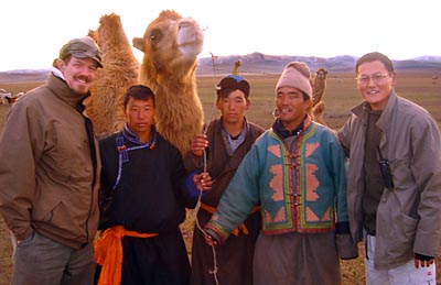 Gil Crawford (left) visits Mongolia in 2004 to conduct due diligence on a microfinance institution, XAC Bank. At right is bank CEO Ganhuyag Ch.Hutagt; in middle are MFI clients. MicroVest made its initial investment in XAC, of $1.5 million, a few months later and has continued to provide financial capital since then.