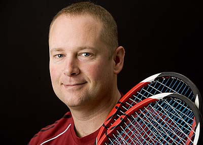 Like any serious player, men’s tennis coach Paul Gastonguay ’89 never travels with just one racquet. Photograph by Phyllis Graber Jensen.
