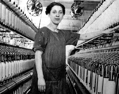 This 1920 photograph shows millworker Elizabeth Gagne amidst the Bates Mill spindles. Photograph courtesy of Museum L-A.