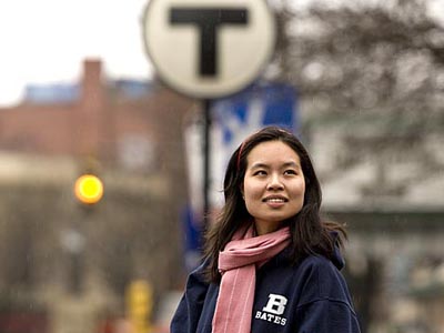 Somerville is an incubator for young alums adjusting to the real world, says Swita Charansomboon 04, standing in Davis Square near a familiar mass-transit symbol. Photograph by Phyllis Graber Jensen.