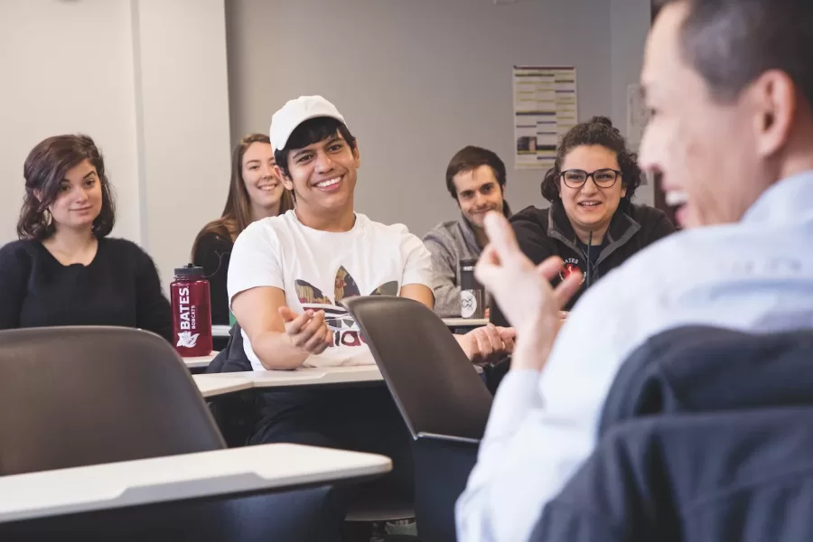 Dr. Voot Yin '96, Assistant Professor at MDI Biological Laboratory, right, reacts while speaking to students in Assistant Professor of Biology Larissa Williams' molecular biology classroom during a Purposeful Work themed class session on April 2, 2018.