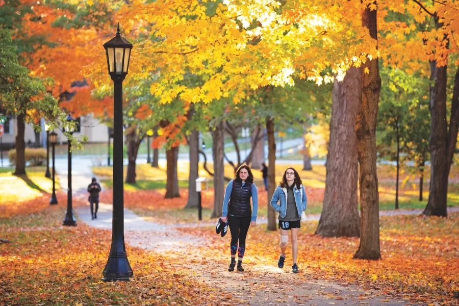 The Bates campus shows off fall colors on the Historic Quad late in the afternoon on Oct. 15, 2019.
Left to right:
Sophie Landes '21 of NYC strolls up the path with Elly Beckerman '22 of Washington, D.C.