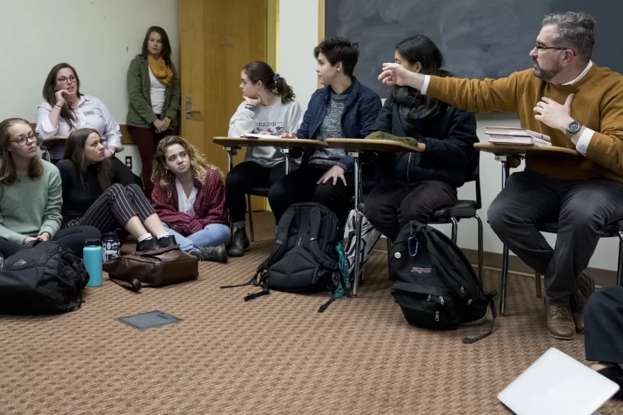 Professor of Politics Steve Engel leads an informal discussion, “Just in Time,” this afternoon in a Pettengill classroom on the Kavanaugh Supreme Court nomination hearings and process.
.
The conversation was hosted by the Bates Feminist Collective.
.
An Affiliated Scholar of the American Bar Foundation in Chicago, Engel’s research and teaching focus on American political development, constitutional law, and social movements, particularly LGBTQ socio-political and legal mobilization.
Co-chairs of the Feminist Collective (FemCo):
Lizzie Ottenstein '20 of NYC, interdisciplinary major (gray sweater and green scarf with long hair down);
Politics major Gwendolyn Whidden '19 of New York City (wearing all black with hair pulled up in bun);
Politics major Annie Canning '20 of Mt. Vernon, N.Y., (wearing black sweater and black and white pants with hair in ponytail)