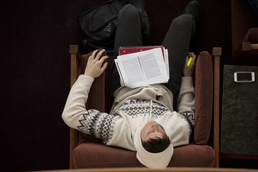 A day in the life of Pettengill Hall, featuring staff, faculty and students engaged in learning, studying, and working, with both internal and external images.

This student, Pieter Cory '22, dosing and studying in the Perry Atrium, said he was preparing for a class on PLTC 125/ "States and Markets" taught by Jason Scheideman, Assistant Dean of the Faculty for Budget and Administration and Lecturer in Politics.