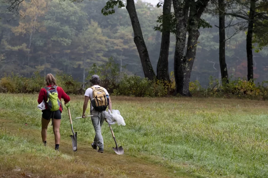 Zoe Knauss '23 of Buffalo, N.Y.,  who will declare as an ES major, and ES major Sam Gilman '22 of Mendham, N.J., , dig for soil in a field.


Prof of Environmental Studies and Christian A. Johnson Prof of Interdisc Studies Holly Ewing and Lecturer in Environmental Studies & Learning Associate in Environmental Studies Camille Parrish take students in the Soils/Lab course for a field trip to Pettengill Farm in Freeport, Maine. A nineteenth century salt-water farm on the estuary of the Harraseeket River, the farm is owned by Freeport Historical Society(FHS). It includes a saltbox house (ca. 1800) on 140 acres of fields, woods, antique apple orchards and salt marsh. Most interesting are the etchings (sgraffitti) found on the plaster walls in the upper chambers of ships, sea monsters, longboats and animals. The farmhouse remains without plumbing, central heat and electricity and is listed in the National Register of Historic Places. Mildred Pettengill was its last resident and lived in the house until 1970.

The students are digging up soil and making observations (soil profiles) before putting it back where it came from.

ENVR 310 - Soils/Lab
Depending on one's point of view, soils are geological units, ecosystems, the foundation of plant life, a place for microbes to live, building material, or just dirt. This course takes a scientific perspective and explores the genesis of soils, their distribution and characteristics, and their interaction with plants. Field studies emphasize description of soils, inferences about soil formation, and placement within a landscape context. Labs investigate the chemistry of soils and their role in forestry and agriculture.