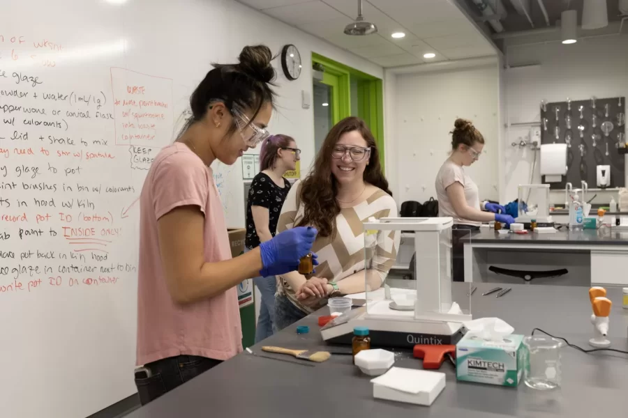 They are jumping for joy.
Women’s varsity rowing teammates Oli Seline ’24 (left) of Delaware, Ohio, and Olivia Dekker ’24 of Bethesda, Md., high five it at the conclusion of their last-ever Bates lab in Bonney 360.
The teammates are students in Assistant Professor of Biochemistry Geneva Laurita’s Short Term course, “Chemistry and the Arts.”
Seline is a biochemistry major with a GEC in “Visible Ideas,” while Dekker is a biochemistry major with a minor in art and visual culture.
The course explores the connection between chemistry and various topics in the arts and arts-related fields. The students learn about the chemistry behind these topics, exploring the literature behind various artistic practices, and applying hands-on techniques in the laboratory involved in various art processes
This year, Laurita asked students to focus on the origins of color, different crafts, print making, jewelry making, dyeing, and art conservation.
Laurita is the recipient of a major National Science Foundation grant of $581,984. The NSF CAREER award, considered to be one of the foundation’s most prestigious awards for faculty members who are just beginning their teaching and research careers, is based on both her scientific research in solid state materials and how she brings undergraduates into that vital area of scientific exploration.
3:18
What the particular lab was about...the lab handout.

Kate Baumler, intern for Geneva’s NSF grant, wearing, black shirt

Benji Richards, ’27, wearing tan shirt
Finian Gunny ’27, gray pullover and blond hair
Charlotte Maffie ’25 with pink tie dyed and hair in bun
Sister Alice Maffie ’27 in t-shirt and pony tail
Nina Greeley ’24 with hair in bun and pink t-shirt
Riley Lund ’26 in gray sweatshirt
Jahan Baker-Wainwright ’25 in green golf 
Rohini Kandasamy ’27 in dark tan Life is cool t-shirt and low bun

Chemistry and the Arts S28, the origin of different crafts, print making, jewelry making, dyeing and art soncserv