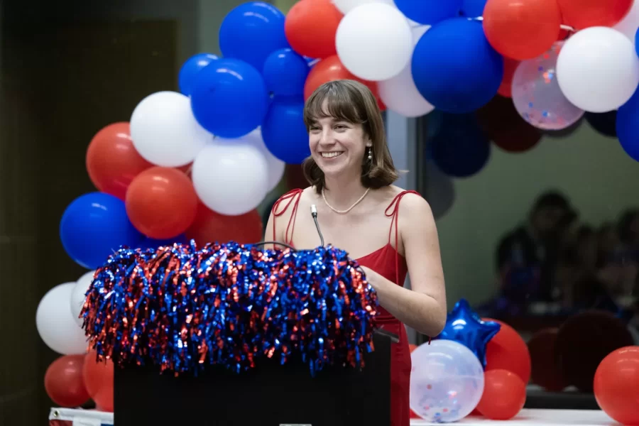 This year's Presidential Campaign Rhetoric class had a ball—an inaugural ball, that is.

On Monday night on the second floor of Commons, "President-elect" Claire Bennett (played by Leah Belber '26 of Washington, D.C.) officially became "President" Bennett after taking the oath of office administered by Professor of Politics Stephen Engel. Here, she is seen with her loving "husband," John Bennett (played by George Wan '25 of Hong Kong), who held a constitutional law textbook during the mock ceremony.

Among other scenes, swipe left to see Vice President Lawrence "Frank" Green (played by Freddie Curtis '25 of Harvard, Mass.) take his oath of office alongside his "wife," Elizabeth Green (played by Claire Bohmer '25 of Steamboat Springs, Colo.). President Bennett also celebrates with her campaign manager, Katherine Moe ’25 of Washington, D.C.

Win or lose, members of the Presidential Campaign Rhetoric class and their friends toasted to a job well done with tasty treats and sparkling cider. Taught by Stephanie Kelley-Romano (@profskr), professor of rhetoric, film, and screen studies, the popular rhetoric course is affectionately known by its acronym "PCR." It offers an intensive and immersive interdisciplinary experience, where mock campaigns run ads, deliver speeches, navigate scandals, and engage with "the media"—also staffed by PCR classmates.

Congratulations to both campaigns and the PCR media coverage from "The Political Times" for another successful and hard fought campaign season.