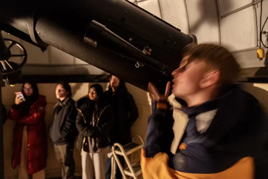 Evan Boxer-Cook ’26, of Scarborough, Maine, leads the Bates Astronomy Club from Carnegie 321 to the Stephens observatory, located on the roof of Carnegie, on January 15, 2025. (Theophil Syslo | Bates College)