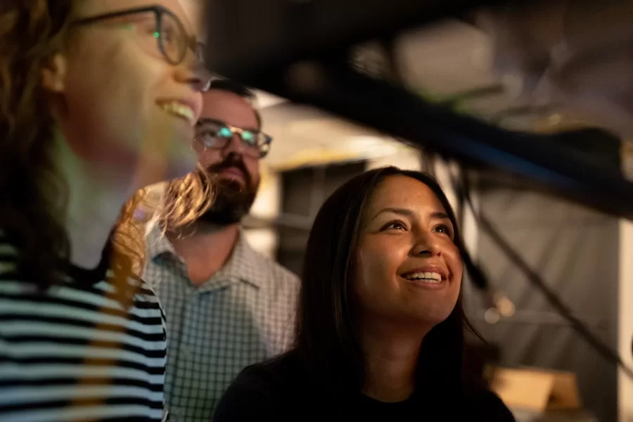Assistant Professor of Physics Ryan Cole works with students in his Carnegie Science 156 lab on June 20, 2025. There is a secondary lab pictured in some of the photos that he and Paloma visited wearing goggles, where they used a laser to measure light frequencies. 

“Every once in a while, science makes sense,” he said at one point to the students.



“Paloma is building an instrument to study very precisely sunlight and specifically the spectrum of sunlight for applications ultimately in exoplanets (planets orbiting other stars)  detection and characterization.

And then this table, which is Carson, Quinn, and Audrey (and Andrew Liu who is not here today) They are measuring how atmospheric gases like methane — specifically green house gases — interact with light to ultimately help us measure those things better in the atmosphere.

Students photographed:

Audrey Schane ’25, physics major, who is working as a research assistant with Cole this summer,
Shown at the computer (striped t-shirt), where she is looking at a gas sample where she’s building something to control gas temperatures, with a vaccuum on the bottom. 

Paloma Rodriguez ’26, a physics major (black t-shirt)

Carson Moellering ’26, physics major, looking at how methane absorbs light in different conditions (light reflecting back and forth in mirrors (white t-shirt)

Qwynn Kobertz ’26, double major in physics and studio art, using a DSR laser exploring how to use this laser in a methane detecting app. (sunglasses on head) Here are two quick links that may help with some context for what we're doing in the lab.

My research website: https://sites.google.com/bates.edu/colelab/research-areas?authuser=0

NIST Article on optical frequency combs: https://www.nist.gov/topics/physics/optical-frequency-combs