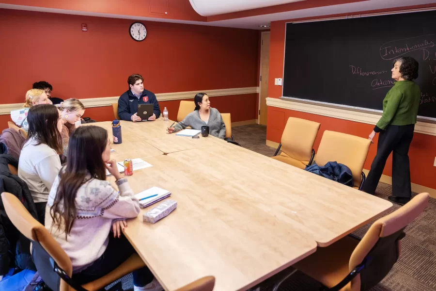 A professor presents to a small group of students during a Race and Tobacco class in Roger Williams Hall.