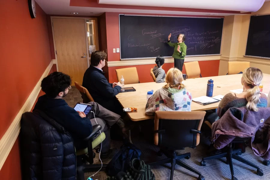 A professor presents to a small group of students during a Race and Tobacco class in Roger Williams Hall.