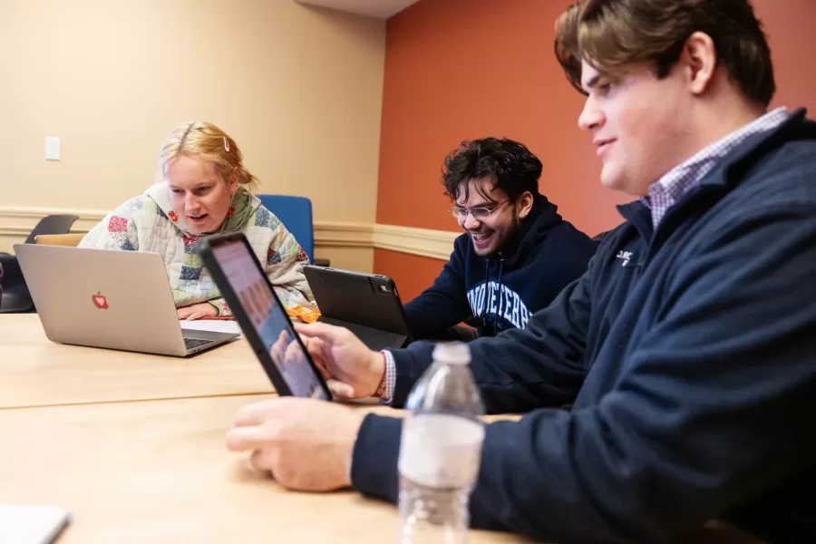Three students engage in a class discussion during a Race and Tobacco class in Roger Williams Hall.