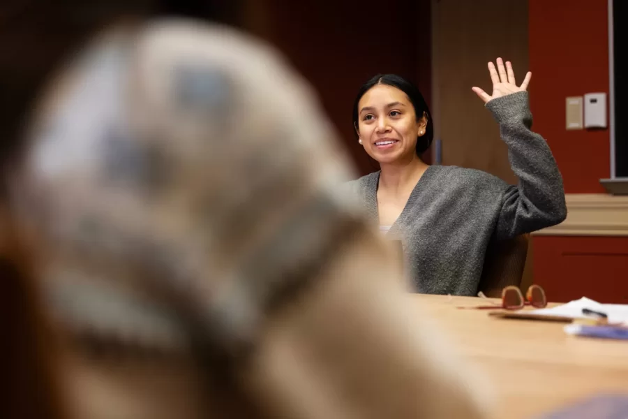 A student raises their hand during a Race and Tobacco class in Roger Williams Hall.