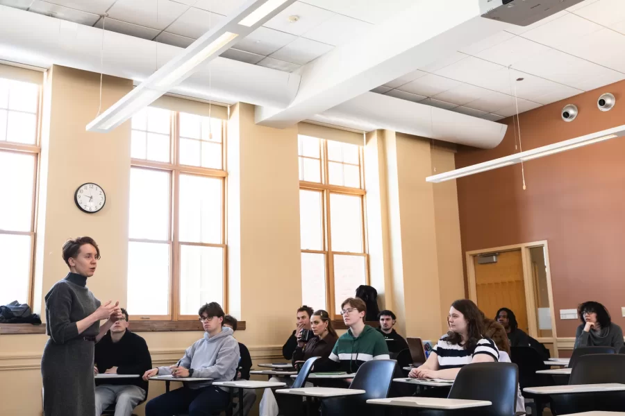 A professor stands at the front of the classroom teaching an Asian Studies Samurai class in Hedge Hall.