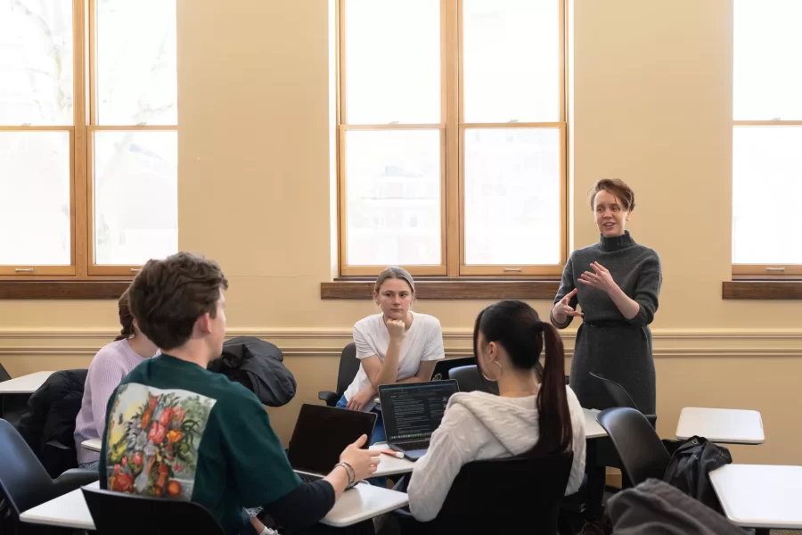 A professor speaks to a small group of students during an Asian Studies Samurai class in Hedge Hall.