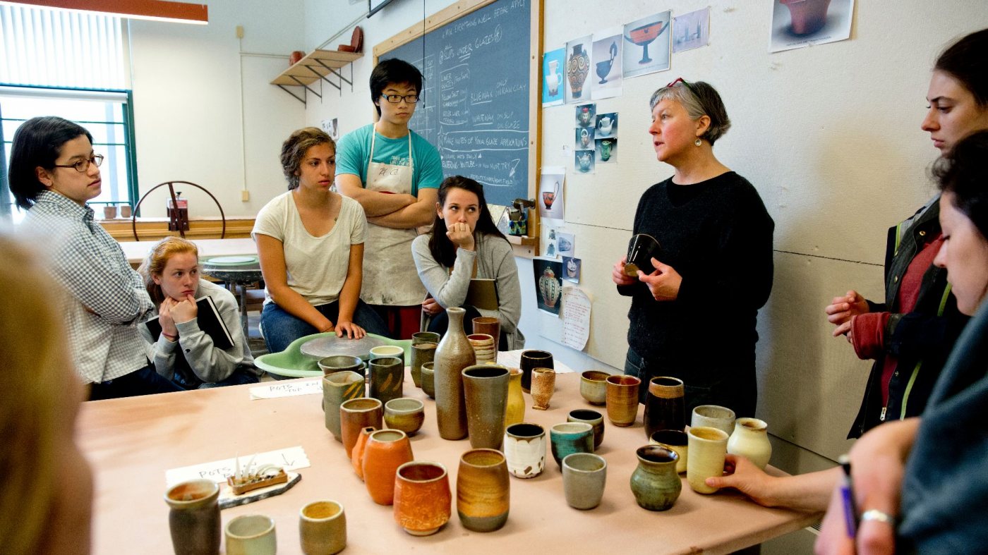 Visiting Assistant Professor Susan Dewsnap, “Soda Firing,” a Short Term offering in Art and Visual Culture, described as “various clays, slips and glazes are employed in exploration of the techniques used by the pioneers of the soda-firing process, as well as its current practitioners.”Suasan: “It’s a class focusing on atmospheric firing using a particular kind of kiln, where when it reaches its maturing temperature we introduce water and soda ash into the kiln and that reacts with the clay body and the glazes and cause highly variable results in the firing. It’s exciting and can be very disappointing. You just can’t be too invested. With all kiln firings, I always say it’s a little bit like Christmas. You have huge expectations and you think you know what things are going to look like. So you’re always very excited and very happy, and then there’s always this phase of disappointment. It’s kind of learning not to have too many expectations. Live with the work you get out of the kiln and then evaluate it after you’ve had that little period of living with it instead of passing judgment right away.”