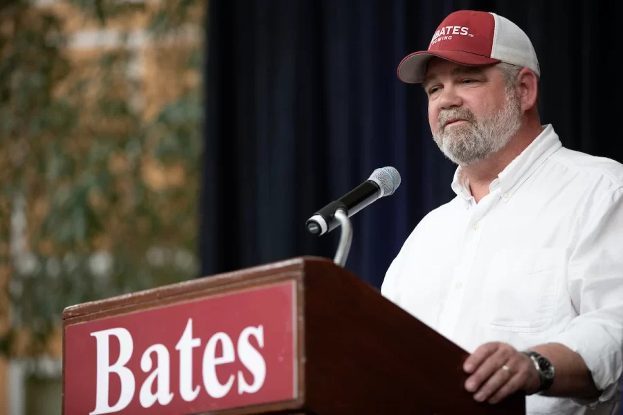 Bates Rowing head coach Peter Steenstra talks about why the rowing team chose to dedicate the new shell to Ralph Sylvester ’50 at Perry Atrium in Pettengill Hall on April 29, 2023. Coach Steenstra presented Sylvester with a blade during the dedication ceremony, making Sylvester the only non-rower to receive one.